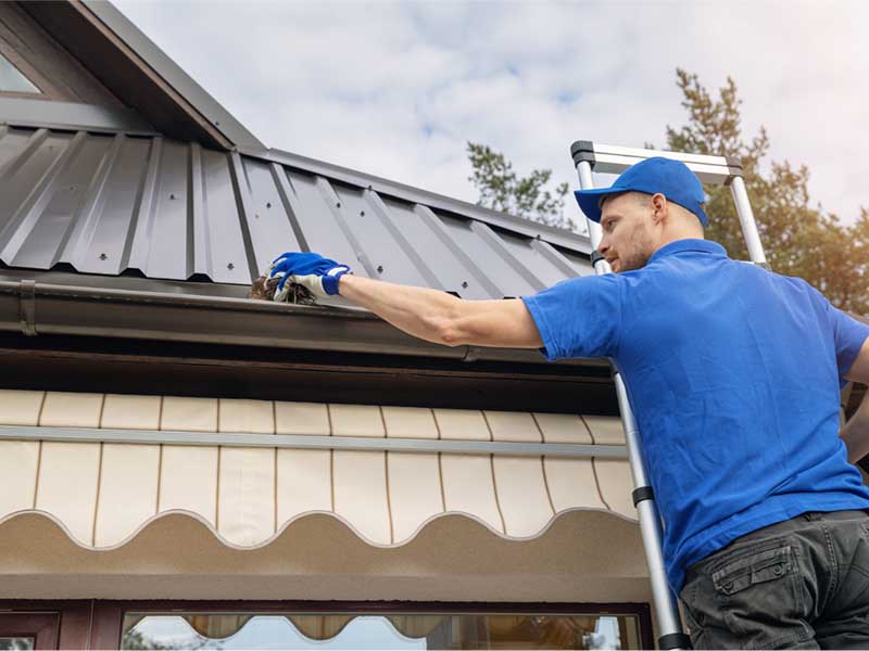 Riteway Roofing, your local expert in Oklahoma City, Myrtle Beach, and Charleston, South Carolina, diligently installing a new rain gutter to protect and beautify your home.